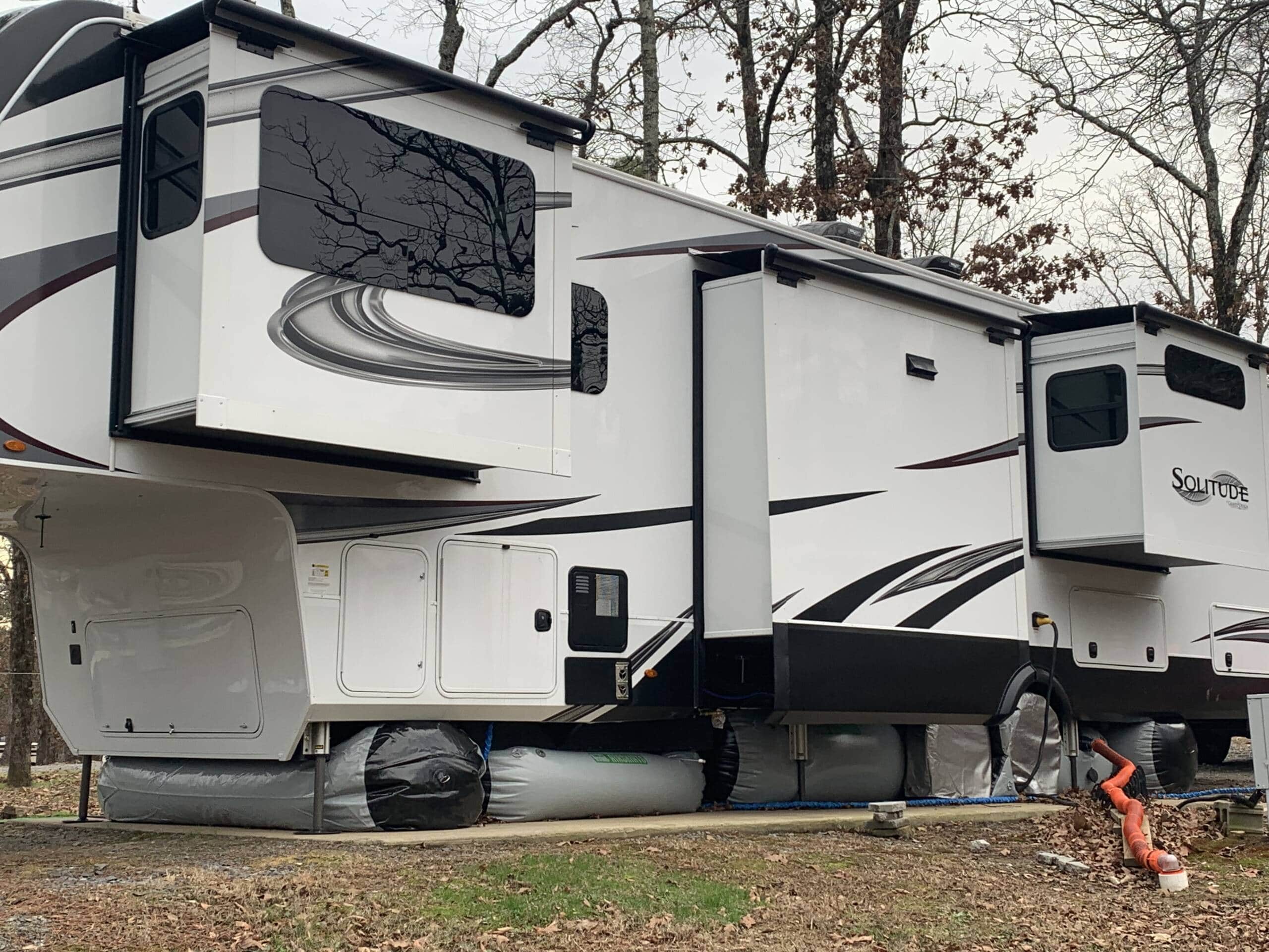 grand design solitude with rv skirts on from drivers side