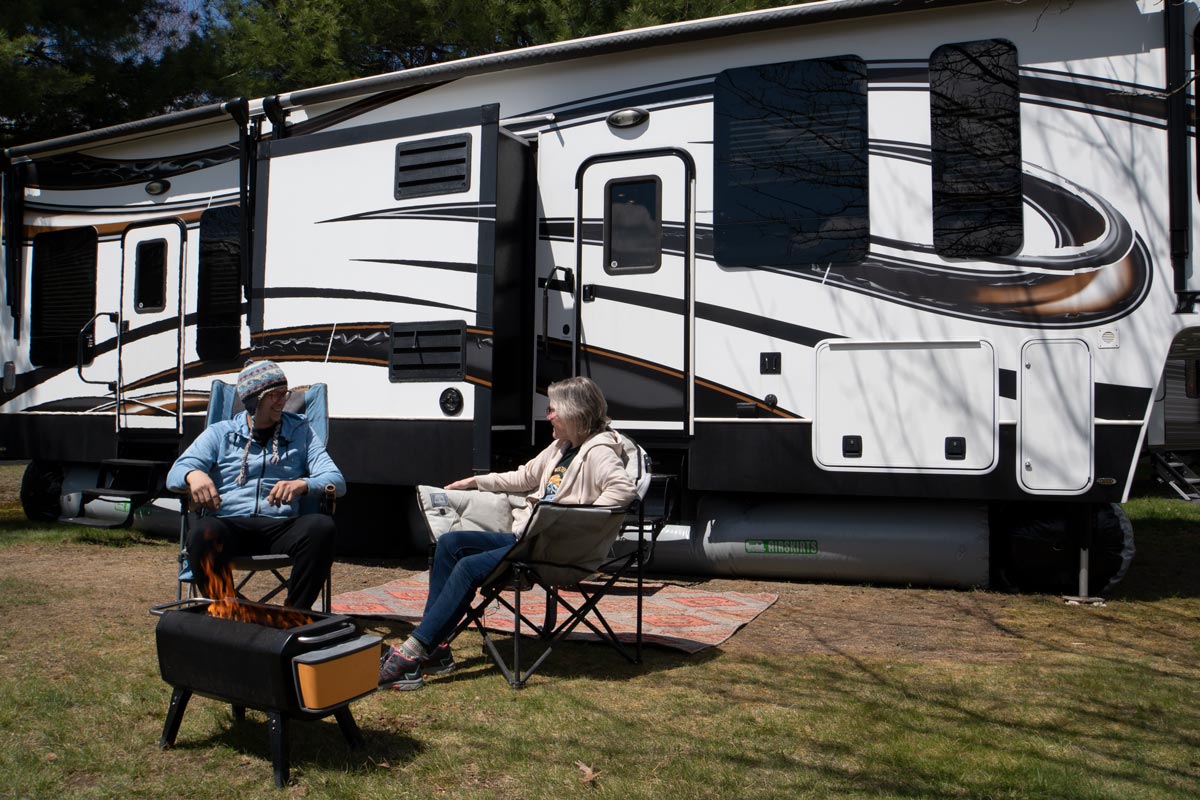 Couple in front on fifth wheel with AirSkirts RV Skirting