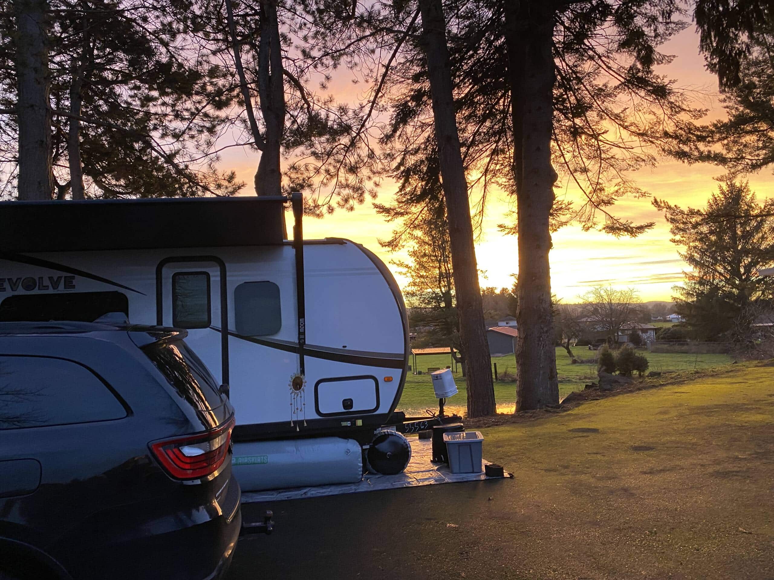 skirts on travel trailer at sunset during warm summer