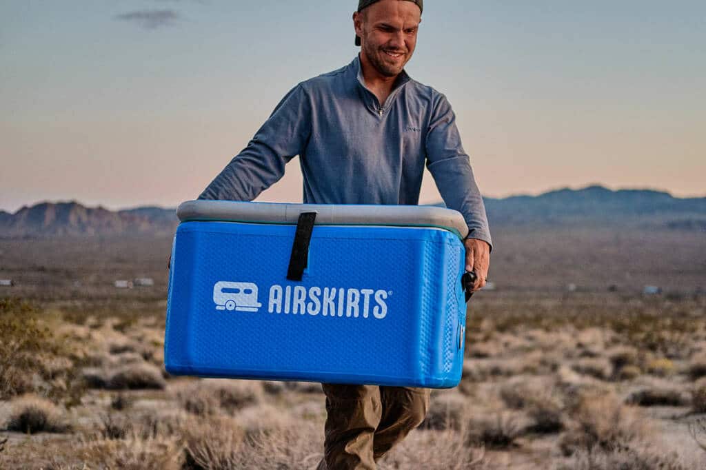 man carrying inflatable cooler