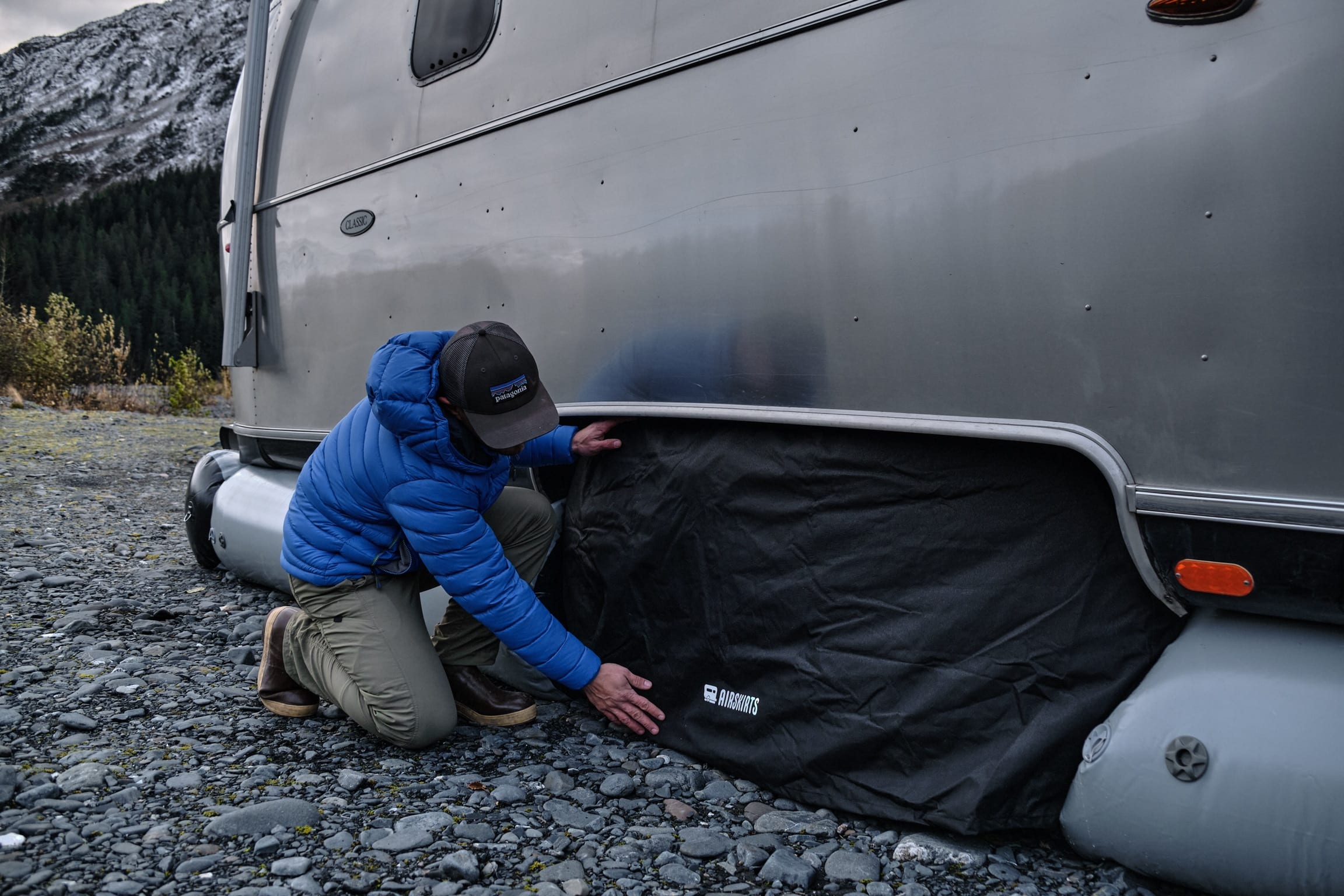 Man installs tore covers on travel trailer rv